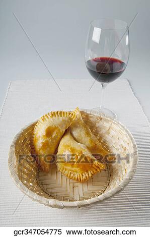 Close-up of a basket of panzarotti served with red wine View Large Photo Image Stock Photography - Close-up of a basket of panzarotti served with red wine. Fotosearch