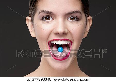 Close-up of a blue candy on a woman's tongue View Large Photo Image Stock Image - Close-up of a blue candy on a woman's tongue. Fotosearch