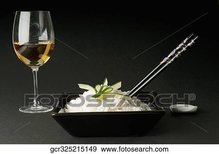 Stock Photo - Close-up of a bowl of cooked white rice served with wine. Fotosearch
