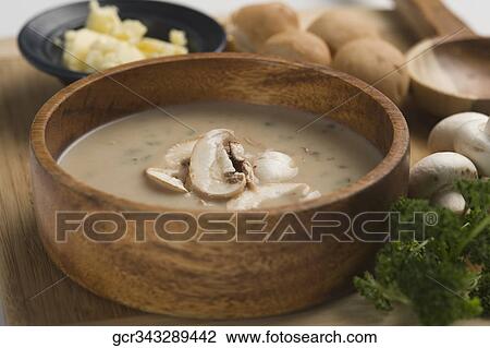Stock Image - Close-up of a bowl of mushroom soup served with breads. Fotosearch