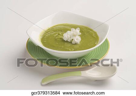 Picture - Close-up of a bowl of pea soup garnished with cream. Fotosearch