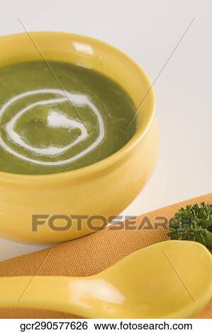 Stock Photograph - Close-up of a bowl of pea soup garnished with cream. Fotosearch