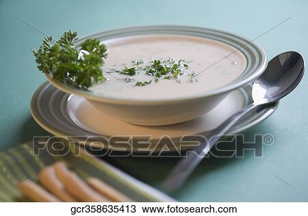 Close-up of a bowl of soup served with breadsticks View Large Photo Image Stock Image - Close-up of a bowl of soup served with breadsticks. Fotosearch