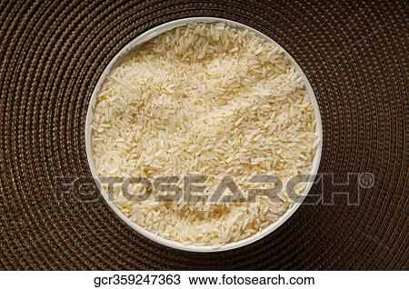 Close-up of a bowl of uncooked rice View Large Photo Image Stock Image - Close-up of a bowl of uncooked rice. Fotosearch
