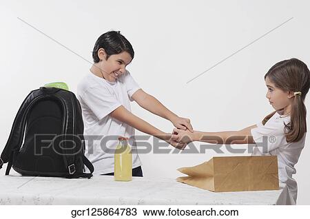 Close-up of a boy and a girl fighting over an apple for lunch View Large Photo Image Stock Image - Close-up of a boy and a girl fighting over an apple for lunch. Fotosearch