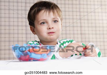 Close-up of a boy eating a candy View Large Photo Image Stock Image - Close-up of a boy eating a candy. Fotosearch