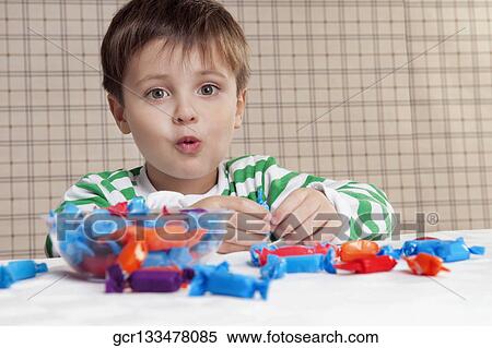 Close-up of a boy eating a candy View Large Photo Image Stock Photography - Close-up of a boy eating a candy. Fotosearch