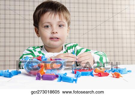 Close-up of a boy eating a candy View Large Photo Image Stock Photography - Close-up of a boy eating a candy. Fotosearch