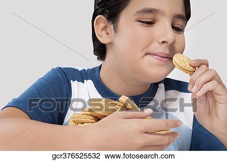 Close-up of a boy eating a cookie View Large Photo Image Stock Image - Close-up of a boy eating a cookie. Fotosearch