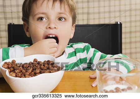 Close-up of a boy eating cereal View Large Photo Image Stock Photography - Close-up of a boy eating cereal. Fotosearch