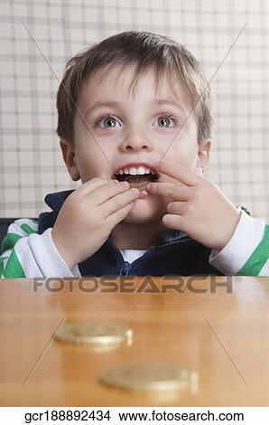 Close-up of a boy eating cookies View Large Photo Image Picture - Close-up of a boy eating cookies. Fotosearch