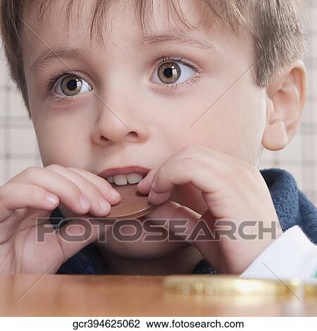 Close-up of a boy eating cookies View Large Photo Image Stock Image - Close-up of a boy eating cookies. Fotosearch