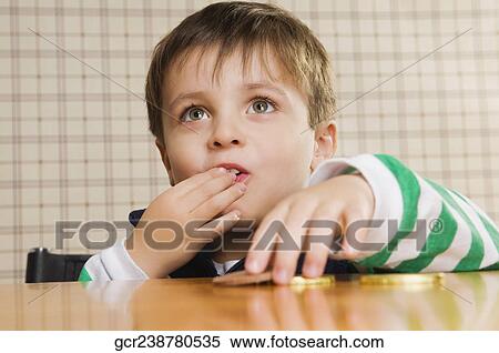 Close-up of a boy eating cookies View Large Photo Image Stock Photography - Close-up of a boy eating cookies. Fotosearch