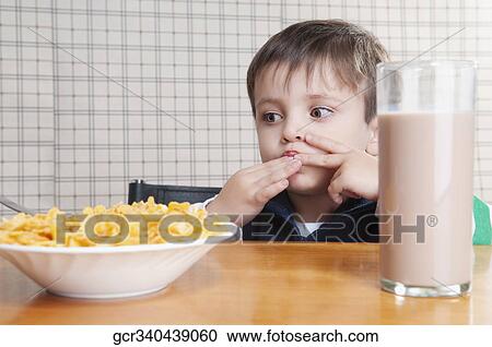 Stock Image - Close-up of a boy eating corn flakes. Fotosearch