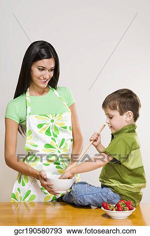 Close-up of a boy helping his mother in cooking View Large Photo Image Stock Image - Close-up of a boy helping his mother in cooking. Fotosearch