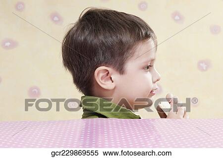 Close-up of a boy holding a chocolate bar View Large Photo Image Stock Photography - Close-up of a boy holding a chocolate bar. Fotosearch