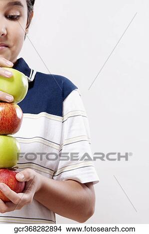 Close-up of a boy holding apples View Large Photo Image Picture - Close-up of a boy holding apples. Fotosearch