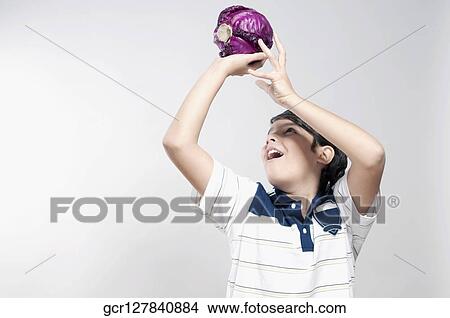 Close-up of a boy holding up a red cabbage View Large Photo Image Picture - Close-up of a boy holding up a red cabbage. Fotosearch