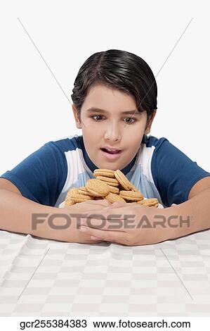 Close-up of a boy hugging a plate of cookies View Large Photo Image Stock Image - Close-up of a boy hugging a plate of cookies. Fotosearch
