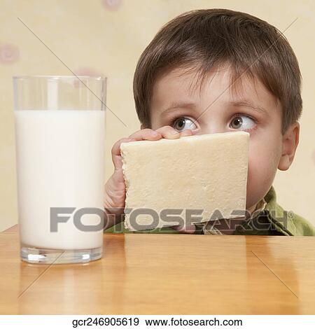 Close-up of a boy looking at a glass of milk View Large Photo Image Stock Photo - Close-up of a boy looking at a glass of milk. Fotosearch