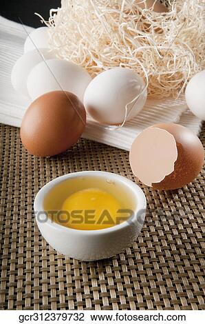 Stock Image - Close-up of a brown egg with white eggs. Fotosearch
