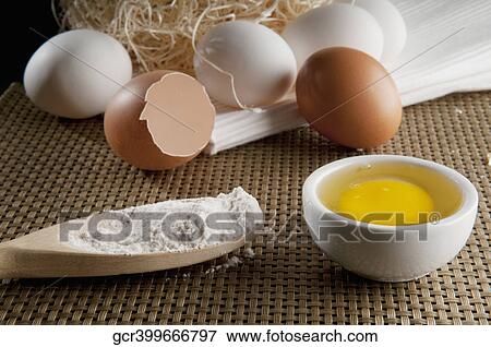 Stock Photo - Close-up of a brown egg with white eggs and flour. Fotosearch