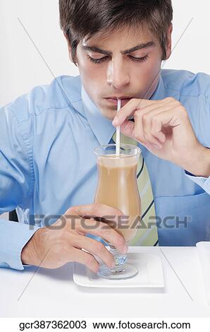 Close-up of a businessman drinking milkshake with a straw View Large Photo Image Stock Image - Close-up of a businessman drinking milkshake with a straw. Fotosearch