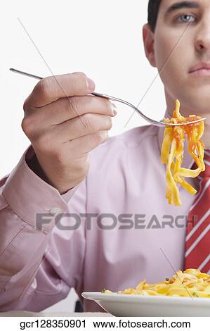Close-up of a businessman eating pasta View Large Photo Image Stock Image - Close-up of a businessman eating pasta. Fotosearch