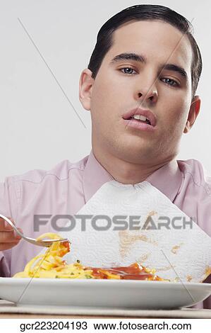 Close-up of a businessman eating pasta View Large Photo Image Stock Image - Close-up of a businessman eating pasta. Fotosearch