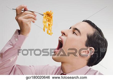 Close-up of a businessman eating pasta View Large Photo Image Stock Photograph - Close-up of a businessman eating pasta. Fotosearch