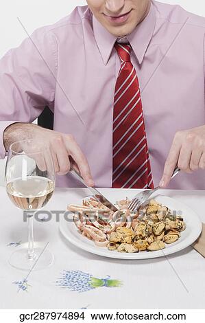 Close-up of a businessman having lunch View Large Photo Image Picture - Close-up of a businessman having lunch. Fotosearch