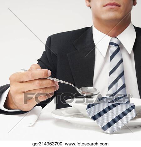 Close-up of a businessman with his tie in a soup bowl View Large Photo Image Stock Image - Close-up of a businessman with his tie in a soup bowl. Fotosearch