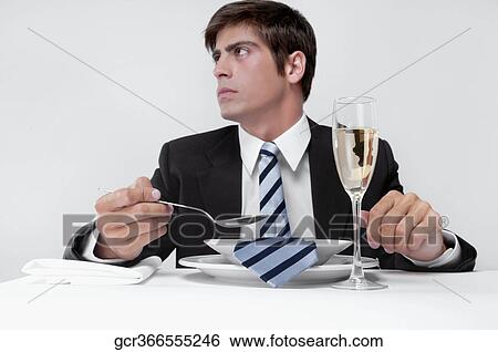 Stock Photograph - Close-up of a businessman with his tie in a soup bowl. Fotosearch