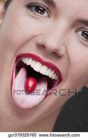 Close-up of a cherry tomato on a woman's tongue View Large Photo Image Stock Image - Close-up of a cherry tomato on a woman's tongue. Fotosearch