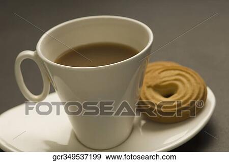 Close-up of a cookie with a cup of tea View Large Photo Image Stock Photo - Close-up of a cookie with a cup of tea. Fotosearch