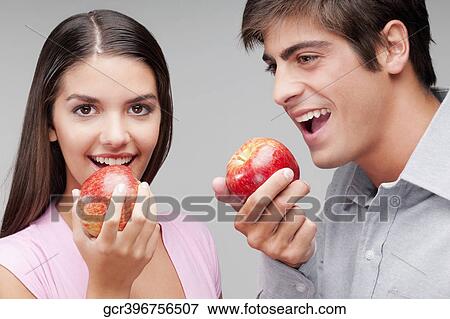 Close-up of a couple eating apples View Large Photo Image Stock Photo - Close-up of a couple eating apples. Fotosearch