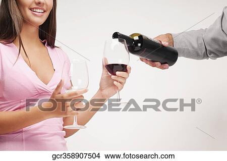 Close-up of a couple enjoying red wine View Large Photo Image Picture - Close-up of a couple enjoying red wine. Fotosearch