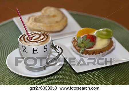 Close-up of a cup of coffee with French hearts and a fruit tart View Large Photo Image Stock Image - Close-up of a cup of coffee with French hearts and a fruit tart. Fotosearch