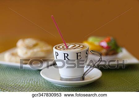 Close-up of a cup of coffee with French hearts and a fruit tart View Large Photo Image Stock Image - Close-up of a cup of coffee with French hearts and a fruit tart. Fotosearch