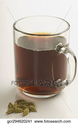 Stock Image - Close-up of a cup of herbal tea with cardamoms. Fotosearch