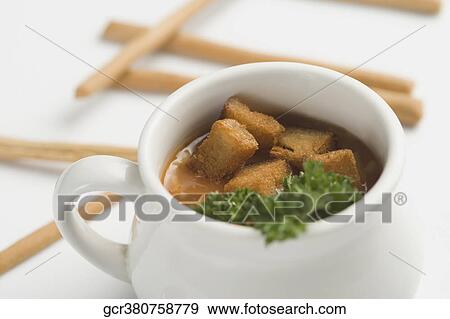 Stock Photo - Close-up of a cup of tomato soup with bread cubes. Fotosearch