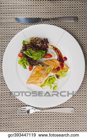 Close-up of a dish of fish fillets View Large Photo Image Stock Photo - Close-up of a dish of fish fillets. Fotosearch