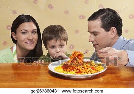 Close-up of a family sharing a platter of fettuccine pasta View Large Photo Image Stock Image - Close-up of a family sharing a platter of fettuccine pasta. Fotosearch