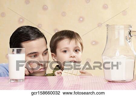 Close-up of a father with his son at a breakfast table View Large Photo Image Stock Image - Close-up of a father with his son at a breakfast table. Fotosearch