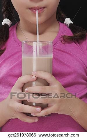 Close-up of a girl drinking chocolate milkshake View Large Photo Image Stock Photograph - Close-up of a girl drinking chocolate milkshake. Fotosearch
