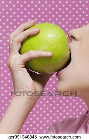 Close-up of a girl eating an apple View Large Photo Image Stock Photography - Close-up of a girl eating an apple. Fotosearch