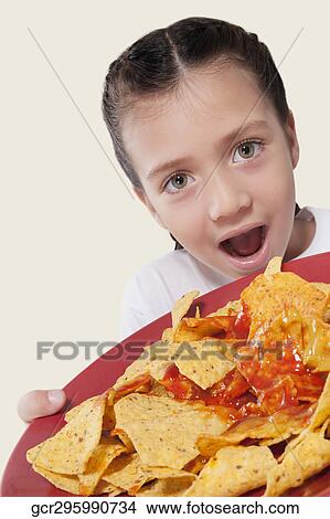 Close-up of a girl holding a platter of nachos View Large Photo Image Picture - Close-up of a girl holding a platter of nachos. Fotosearch