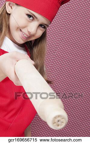Close-up of a girl holding a rolling pin View Large Photo Image Stock Photography - Close-up of a girl holding a rolling pin. Fotosearch