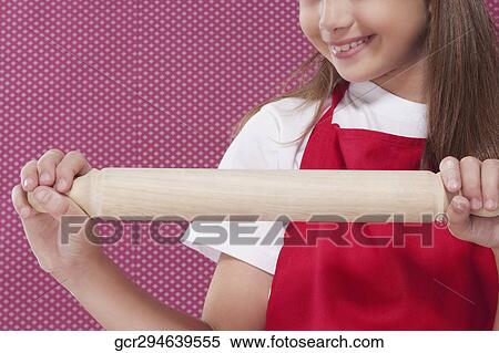 Close-up of a girl holding a rolling pin View Large Photo Image Stock Photography - Close-up of a girl holding a rolling pin. Fotosearch