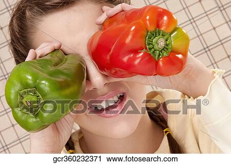 Close-up of a girl holding bell pepper in front of her eyes View Large Photo Image Stock Image - Close-up of a girl holding bell pepper in front of her eyes. Fotosearch